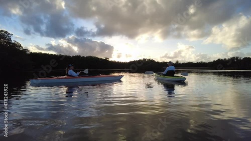 Active senior and young woman kayaking on calm waters of Paurotis Pond in Everglades National Park, Florida on sunny winter afternoon 4K. photo