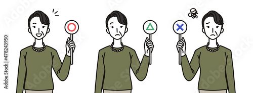 まる・ばつ・さんかくの札を持つシニア女性