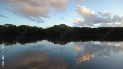 Active senior and young woman kayaking on calm waters of Paurotis Pond in Everglades National Park, Florida on sunny winter afternoon 4K. photo