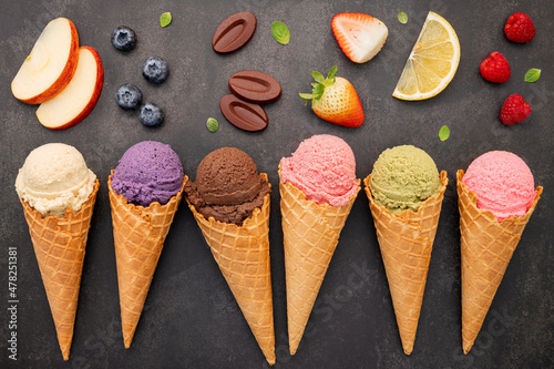 Vászonkép Flat lay ice cream cones collection on dark stone background