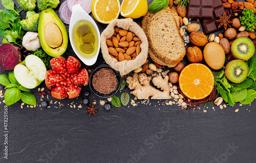 Ingredients for the healthy foods selection. The concept of healthy food set up on dark stone background.