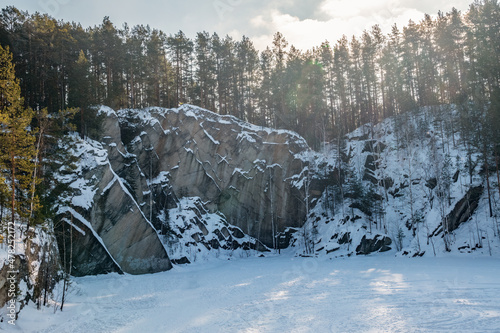 Sheer cliffs and rocks around the Talc quarry in winter in Russia in the town of Sysert, near Yekaterinburg.