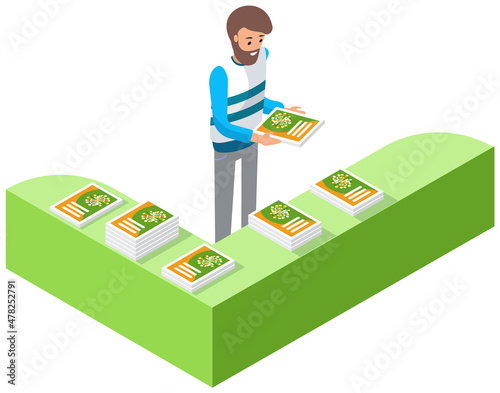 Man stands near advertising platform with books. Marketing company work, promotion, distribution concept. Male character reading product catalog with advertisement. Person near magazines on rack