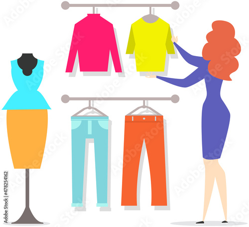 Girl choosing clothes for trousers and shirts fluttered on hangers, elements of wardrobe in store. Woman standing in front of hangers and choosing outfit. Fashion, clothes store, shopping concept.