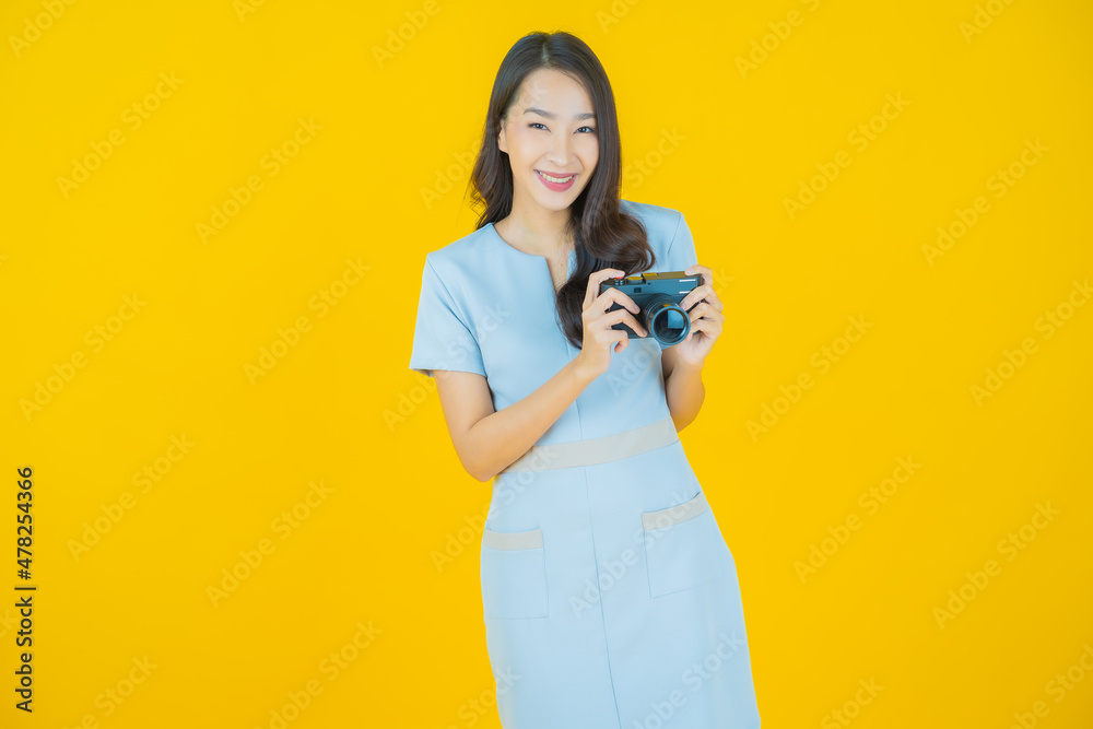Portrait beautiful young asian woman use camera