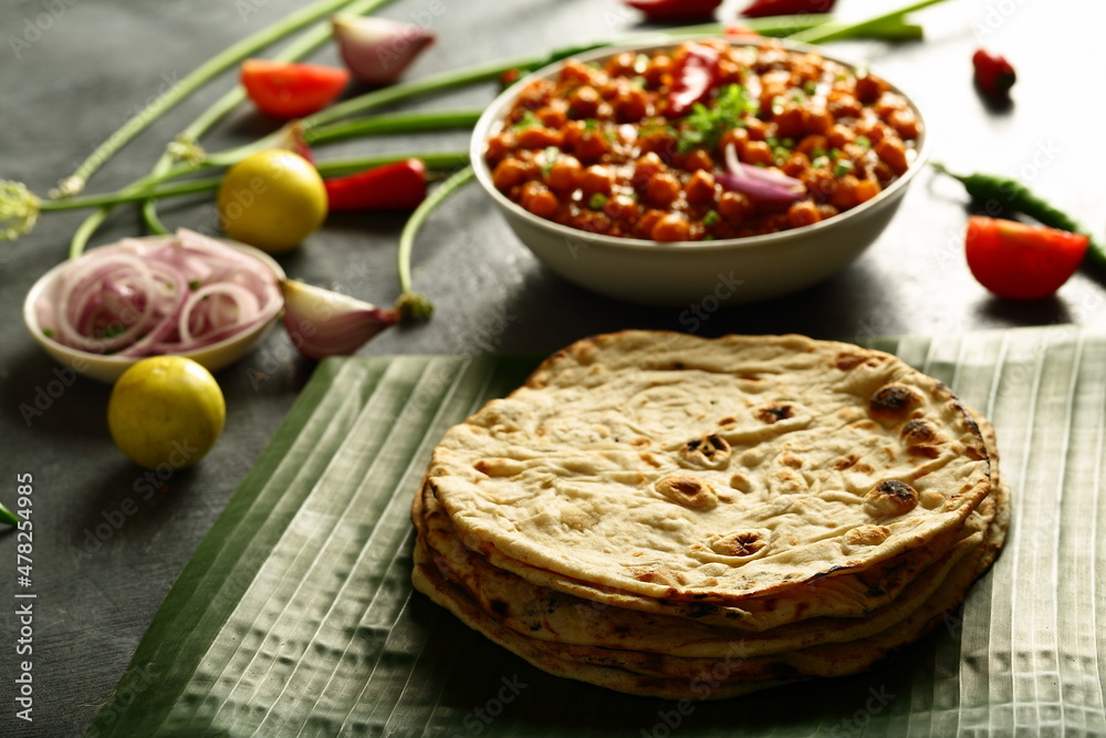 Whole-wheat  roti served with chickpeas curry, chana masla, - Indian vegetarian meal.