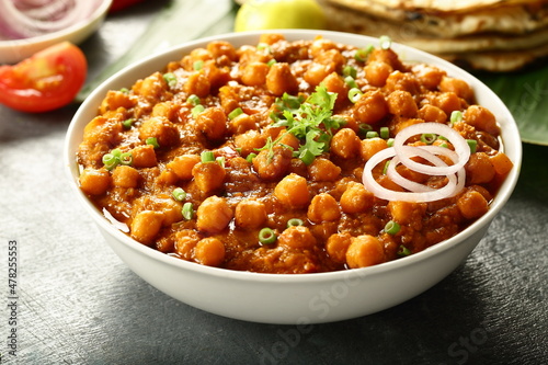 Indian street foods background- chickpeas curry, chana, channa, masala served with chapathi,
