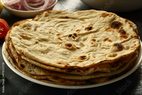 Indian  roti- whole wheat flat bread served with onion salad and chickpea curry.