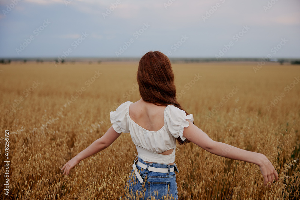 red-haired woman in the field countryside freedom summer unaltered red-haired woman in the field countryside freedom summer unaltered