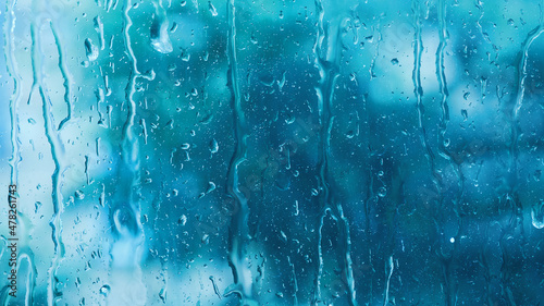 Foto Rain drops close up on window glass outdoors