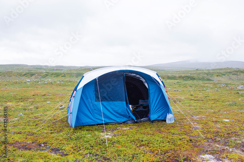 Family tent on the lawn next to North arctic circle, where no trees and grass grow