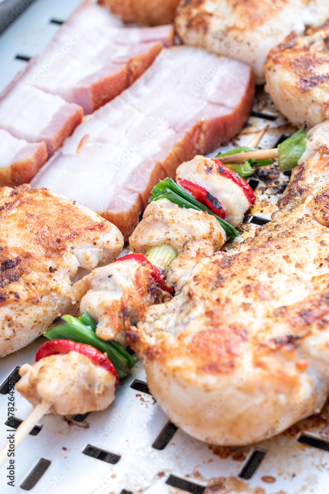 Chicken breast and pork meat pulled in wooden skewer with fresh colorful and tasty vegetables Chicken breast and pork meat pulled in wooden skewer with fresh colorful and tasty vegetables