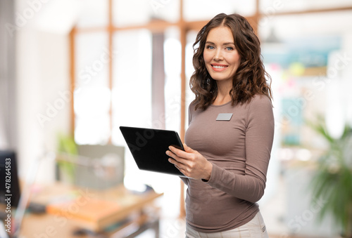 job, work and business concept - happy woman with tablet pc computer name tag over office background Free Download job, work and business concept - happy woman with tablet pc computer name tag over office background - GFXLoad