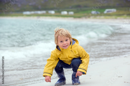 Cute child, running on a Norway white sand beach in summer © Tomsickova