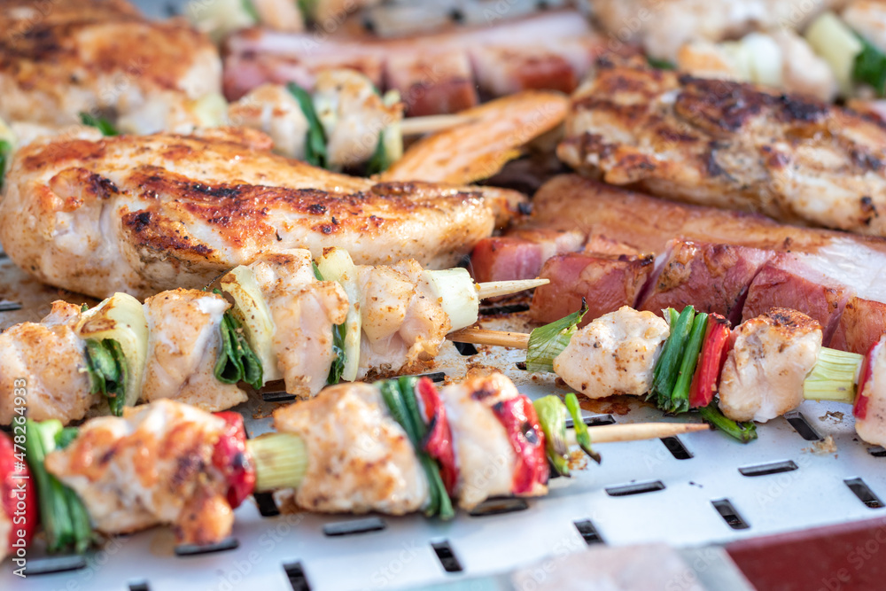 Chicken breast and pork meat pulled in wooden skewer with fresh colorful and tasty vegetables Chicken breast and pork meat pulled in wooden skewer with fresh colorful and tasty vegetables