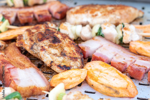 Chicken breast and pork meat pulled in wooden skewer with fresh colorful and tasty vegetables