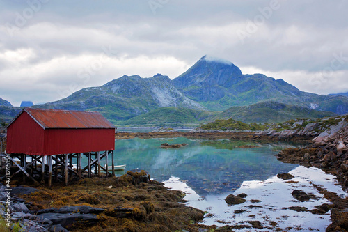Amazing landscape nature with typical red wooden cabins in summer on Lofoten, Norway