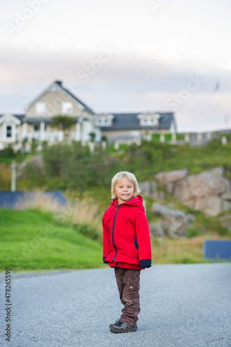 Cute little child, enjoying the view in small A village on the end of Lofoten © Tomsickova