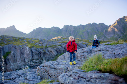 People, enjoying beautiful view of norwegian mountains near A village on a sunny evening, Lofoten, Norway