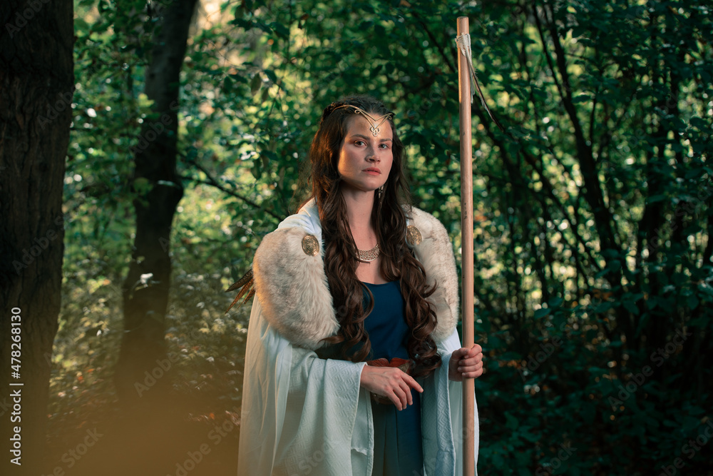 Gorgeous woman in old authentic historical outfit in forest Gorgeous woman in old authentic historical outfit in forest