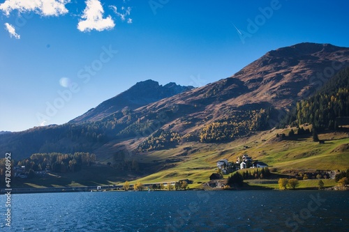 Lake of Davos with sun and blue sky at beautiful autumn day, perfect day to hike. Swiss Alps.. Switzerland, Grison photo