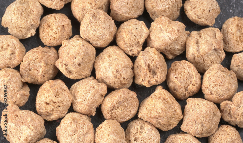 Raw soya chunks on dark background. Healthy, nutritious soybean meat, chunks isolated.Vegan food concept. Raw soya chunks on dark background. Healthy, nutritious soybean meat, chunks isolated.Vegan food concept.