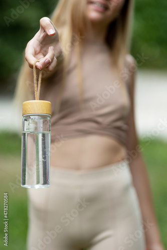 Drink water. Young girl with a bottle of water. High quality photo