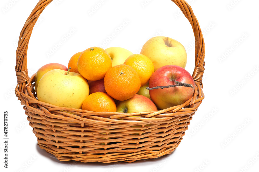 Fruits, apples and tangerines in a wicker basket on white background.