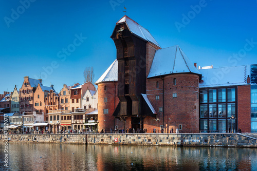 Medieval port crane in Gdansk over the Motlawa river at snowy winter, Poland