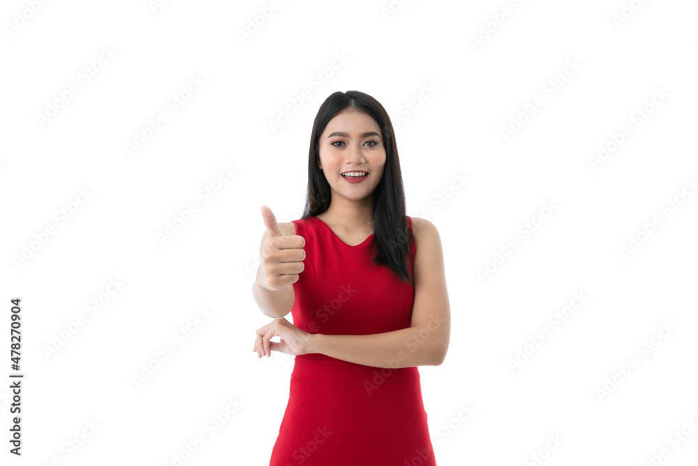 Happy beautiful young Asian woman in casual business red dress is smiling, showing thumbs up while looking at camera, isolated white background and texture with clipping path. Business people concept.