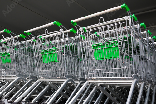 row of empty cart in the supermarket . Shopping center background