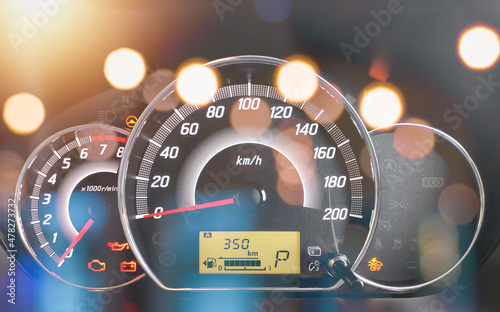 Close-up of the engine, the car's speedometer and the amount of fuel. Cheap oil concept. Hurry to fill up the tank.