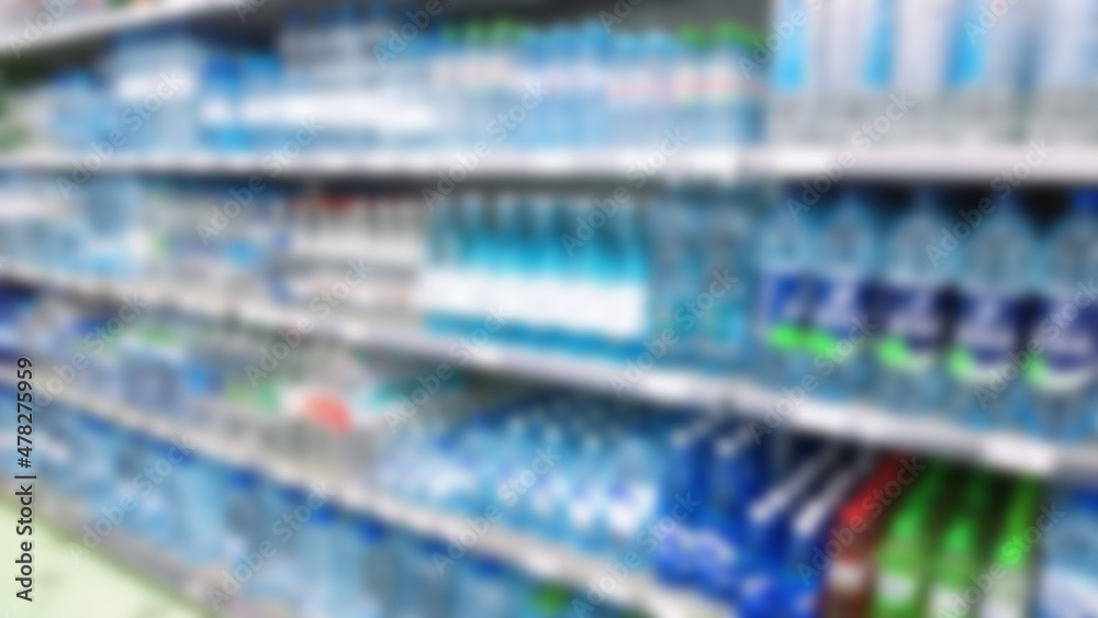 Fototapeta premium Abstract blur image of supermarket background. Defocused shelves with water bottles, food. Grocery shopping. Store. Retail industry. Rack. Discount price. Inflation and economic crisis concept. Aisle.