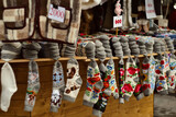 Variaty of traditional hadmade souvenirs from Serbia - woolen socks, jackets, gloves and scarf