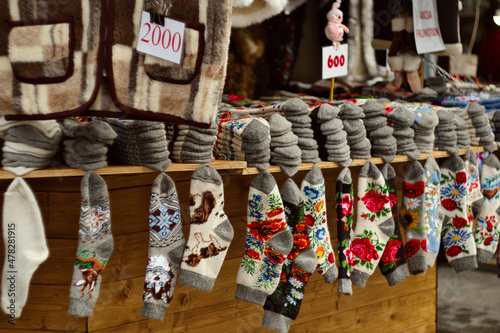 Variaty of traditional hadmade souvenirs from Serbia - woolen socks, jackets, gloves and scarf