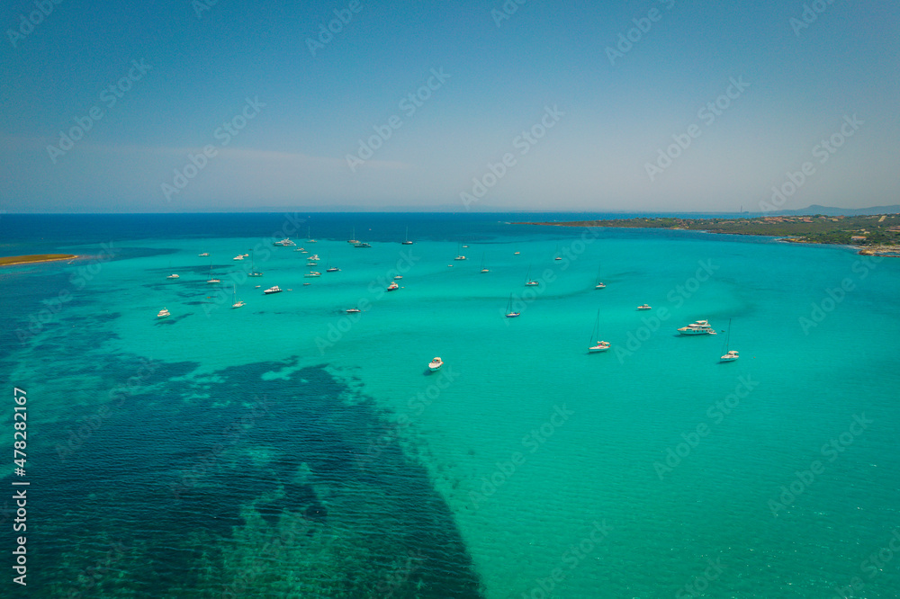 Aerial view of many yachts and sailboats in turquoise water in Mediterranean Sea