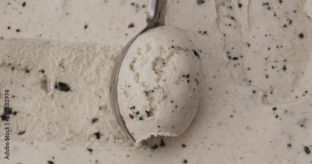 Slow-motion, Cookies and cream ice cream scooped with spoon. The texture of the ice cream has chocolate flakes. Slow-motion, Cookies and cream ice cream scooped with spoon. The texture of the ice cream has chocolate flakes.