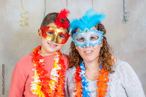 Mother and son with masks celebrating arnival