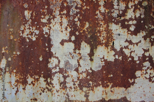 Shabby old design concept of rusty metal surface, brown-white texture of the layout, dark background for creative wallpaper