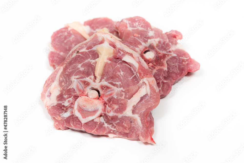 Some raw lamb neck chops on a white background