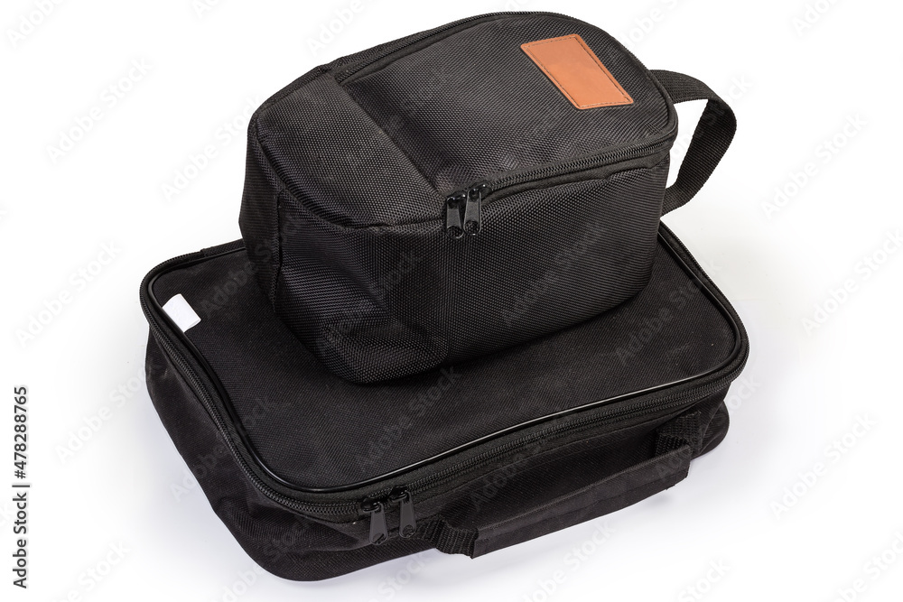 Two different black textile bags with zippers and strap handles Two different black textile bags with zippers and strap handles