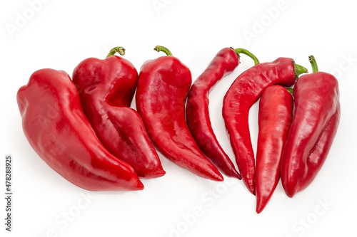 Red pods of bell peppers and chili on white background