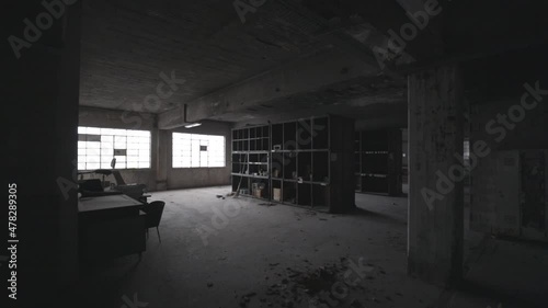 Interior of an abandoned building with few wooden shelf.
Old factory interior.