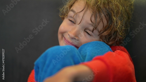 Shy little boy. bashful kid lying down to rest