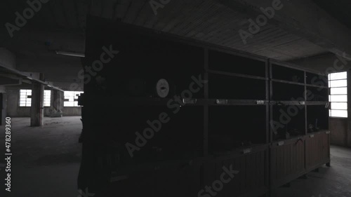 Interior of an abandoned building with few wooden shelf.
Old factory interior.