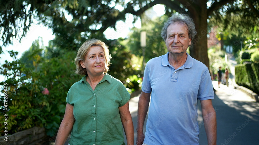 Senior couple walking outside in nature together