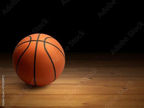 Basketball ball on the parquet with black background