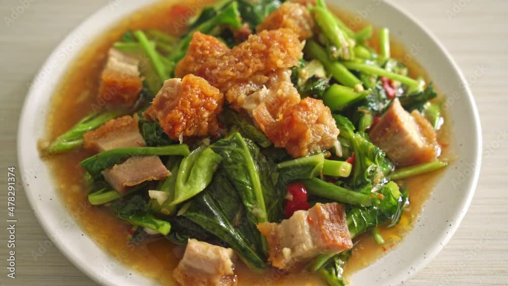 Stir-fried kale vegetable with crispy pork - Asian food style Stir-fried kale vegetable with crispy pork - Asian food style