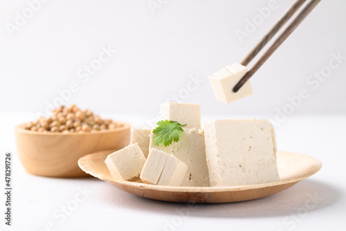 Organic tofu on biodegradable plate with white background, Vegan food ingredients in Asian cuisine, plant based photo