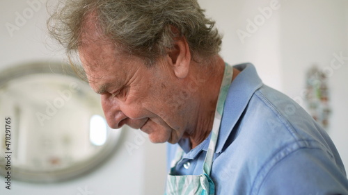 older person cooking preparing meal at home